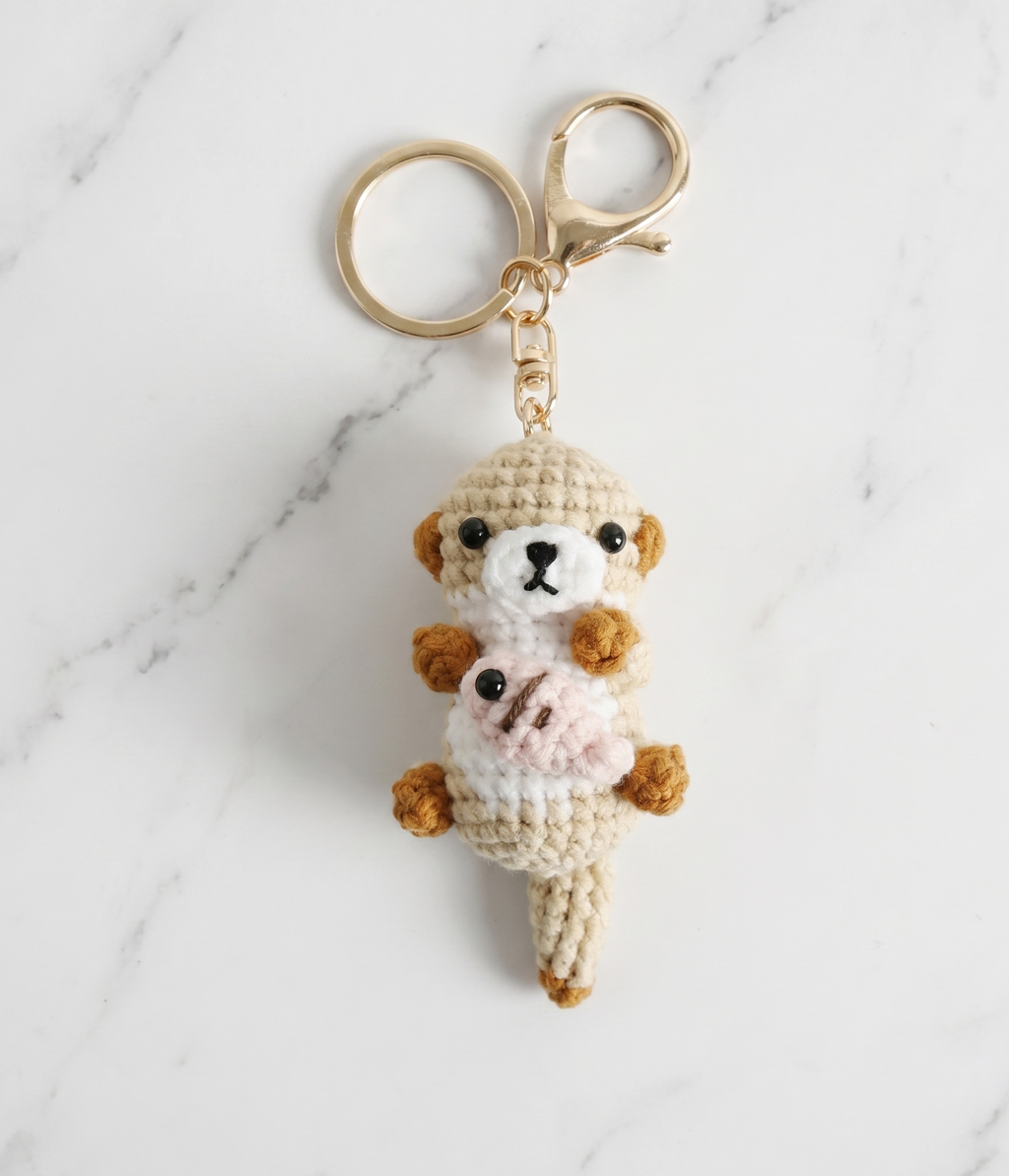 Crochet sea otter and fish keyring close-up detail