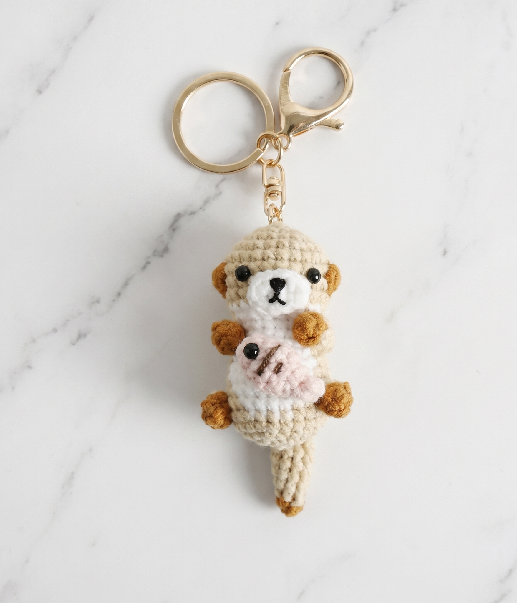 Crochet sea otter and fish keyring close-up detail