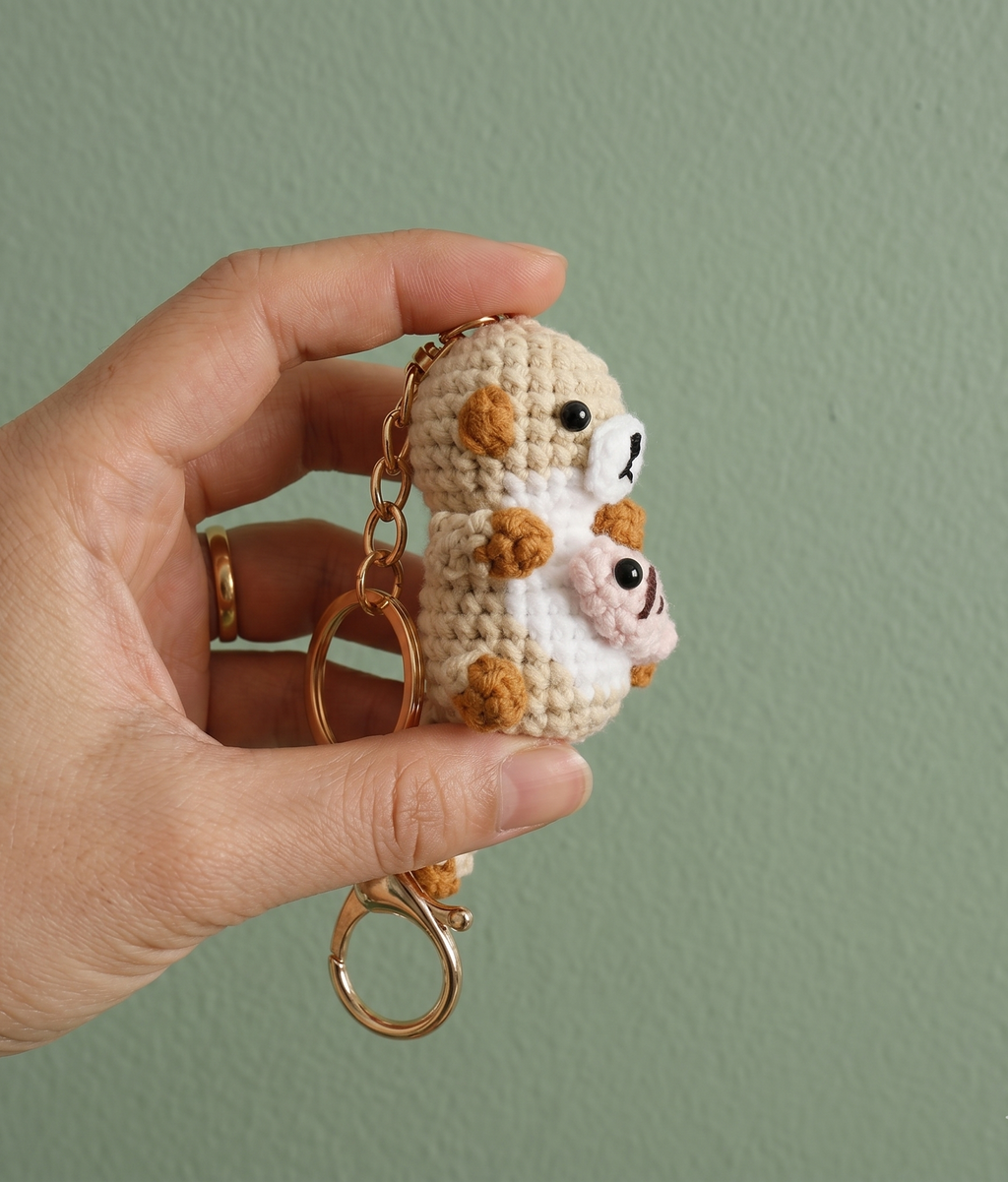 Handmade crochet sea otter with fish keyring showing fish detail