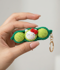 Handmade crochet pea pod keyring in soft green yarn