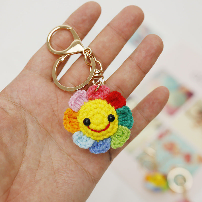 Handmade crochet flower keyring on plain background