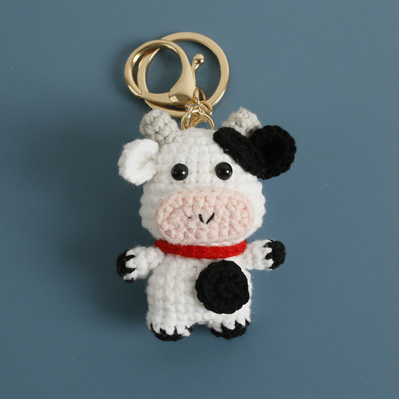 Crochet cow keyring close-up showing spot pattern