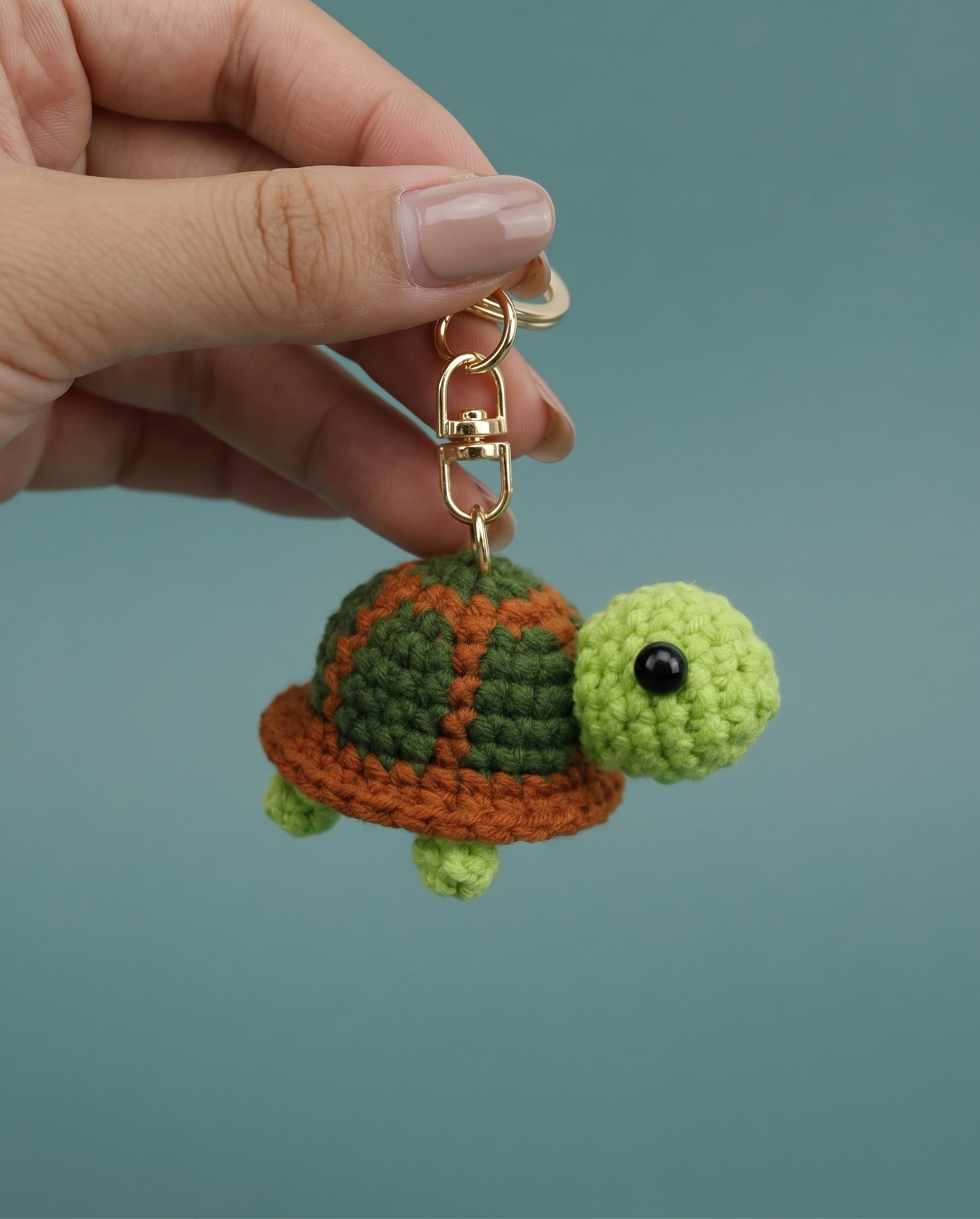 Handmade crochet turtle keyring in soft green yarn