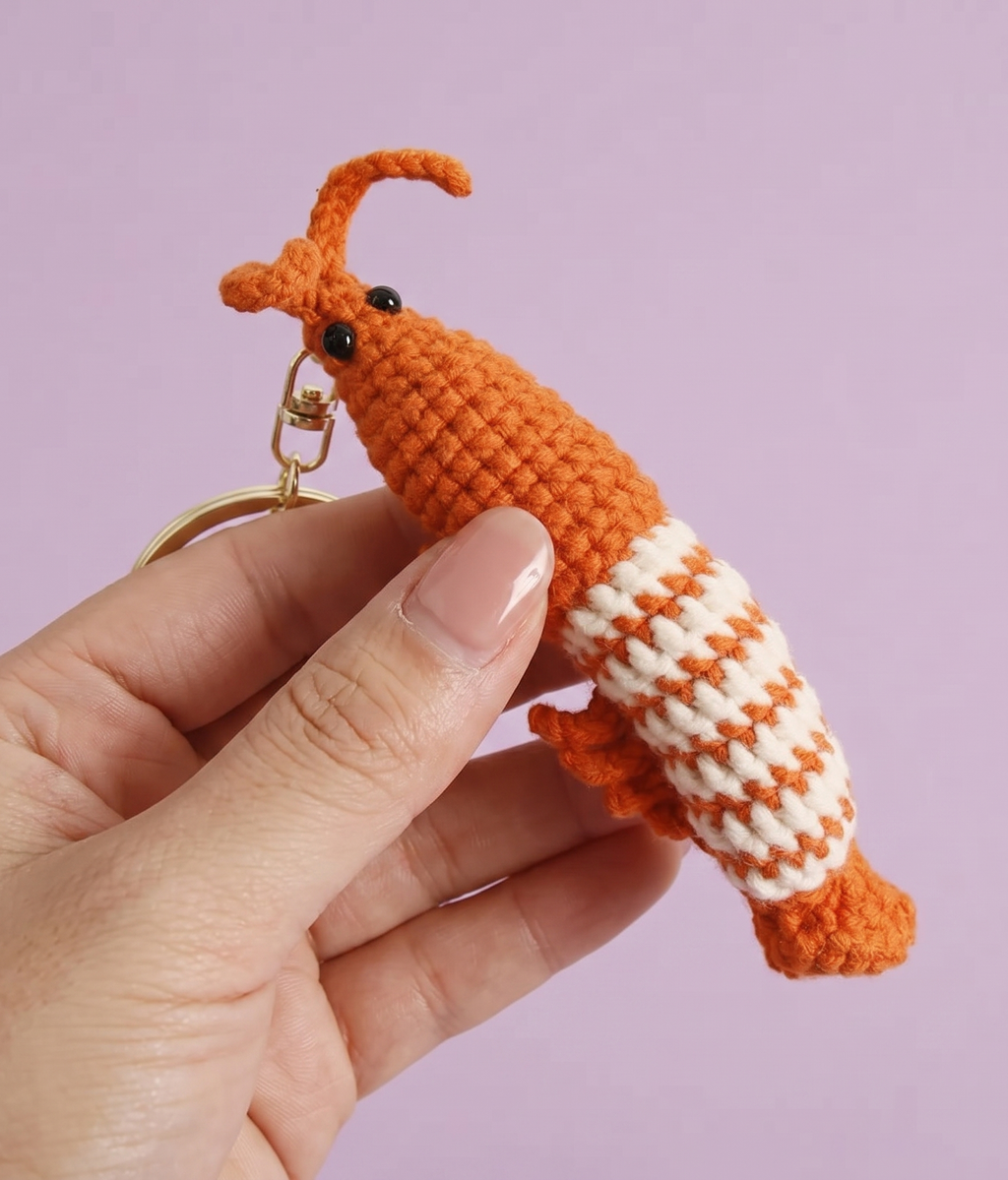 Handmade crochet shrimp keyring in soft pink yarn