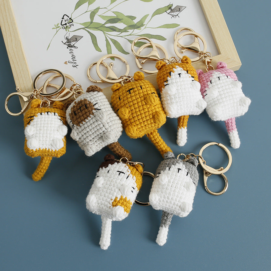 Handmade crochet kitten keyring close-up showing embroidered face