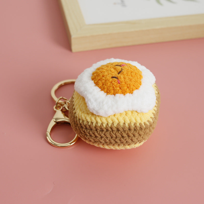 Handmade toast crochet keyring on plain background