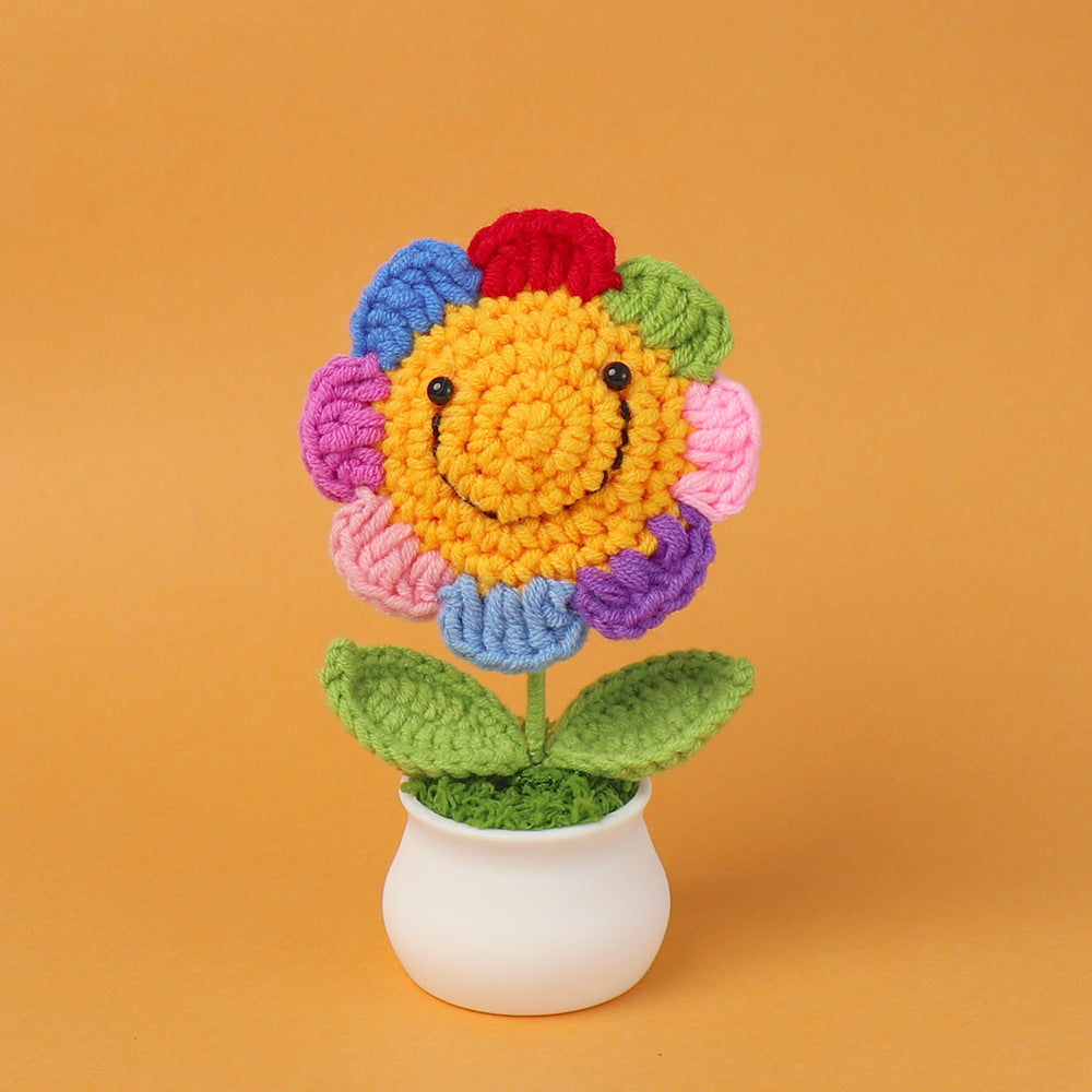 Crochet smiley sunflower pot showing happy embroidered face