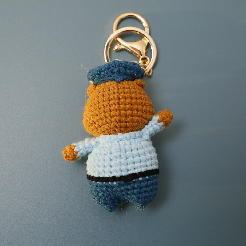 Crochet capybara police keyring on plain background