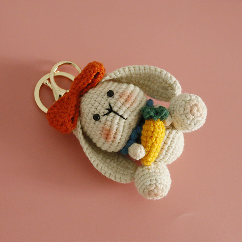 Handmade rabbit crochet keyring on plain background