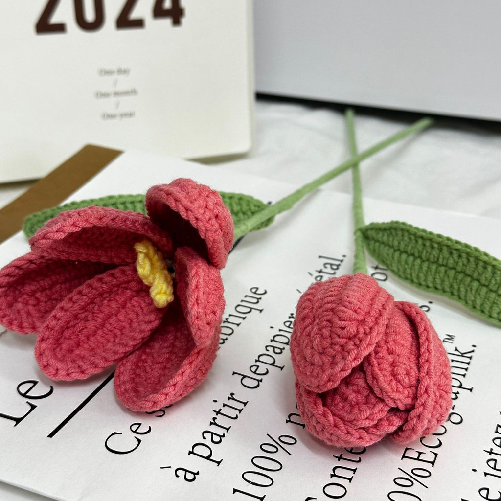 Handmade crochet tulip flower stem on plain background