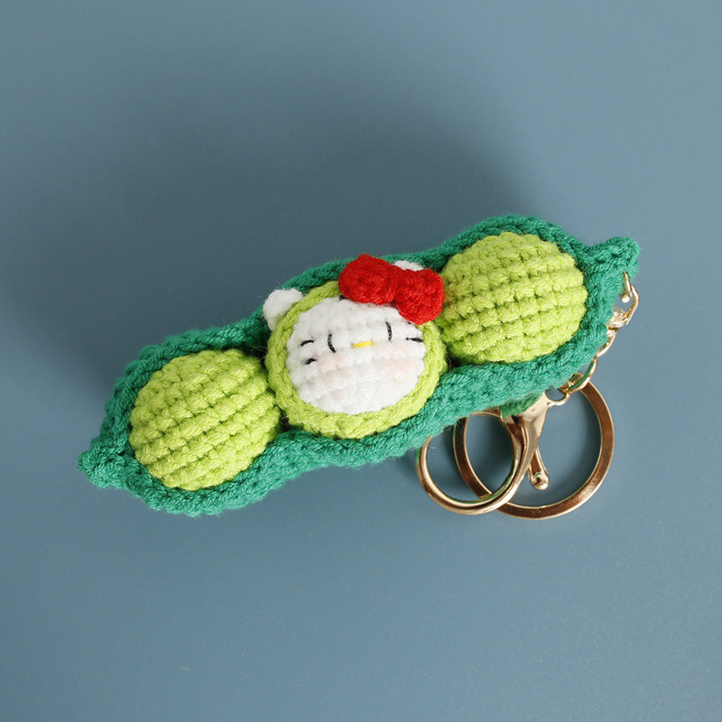 Crochet pea pod keyring showing peas inside the pod