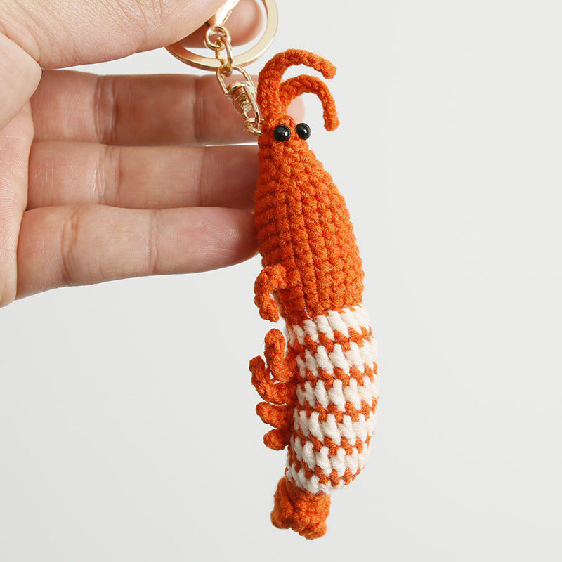 Handmade shrimp crochet keyring on plain background