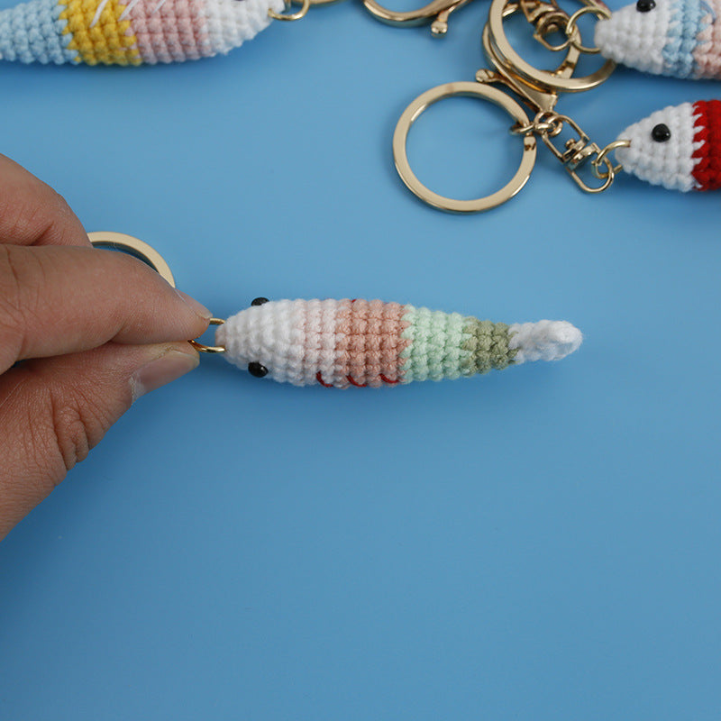 Handmade fish crochet keyring on plain background
