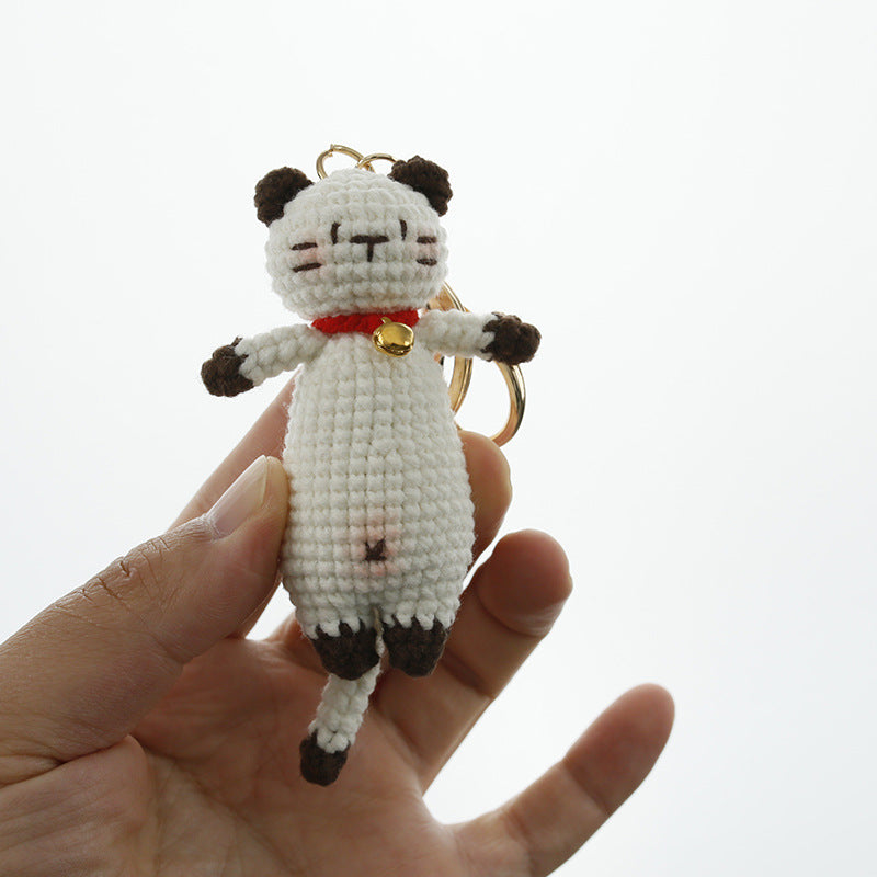 Handmade crochet cat keyring on plain background