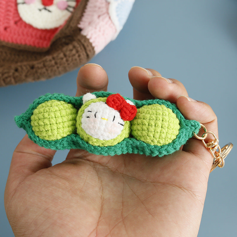 Crochet pea pod keyring on plain background