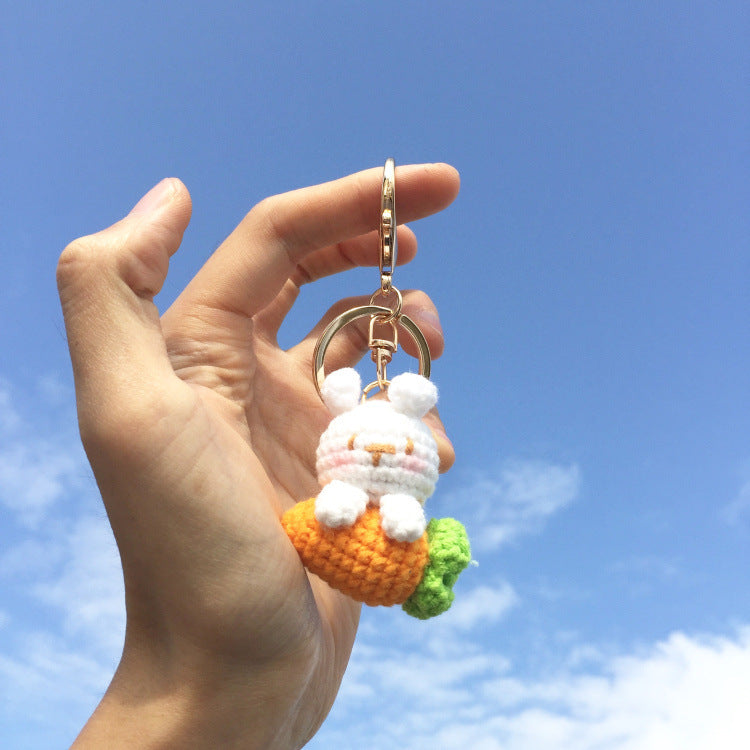 Crochet bunny and carrot keyring on plain background
