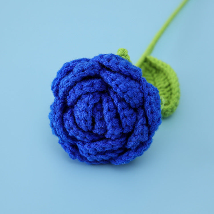 Handmade crochet rose flower stem on plain background