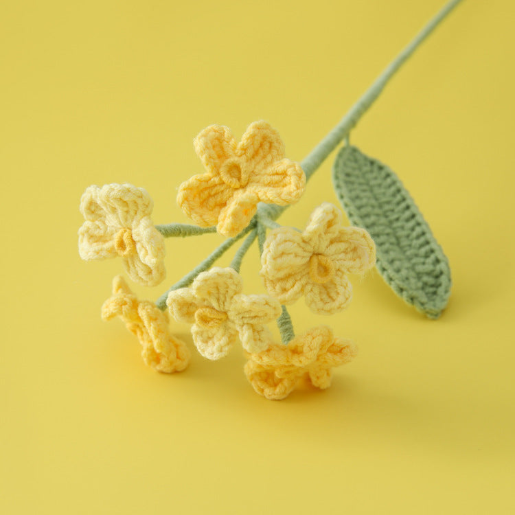 Crochet forget-me-not stem close-up showing tiny blooms