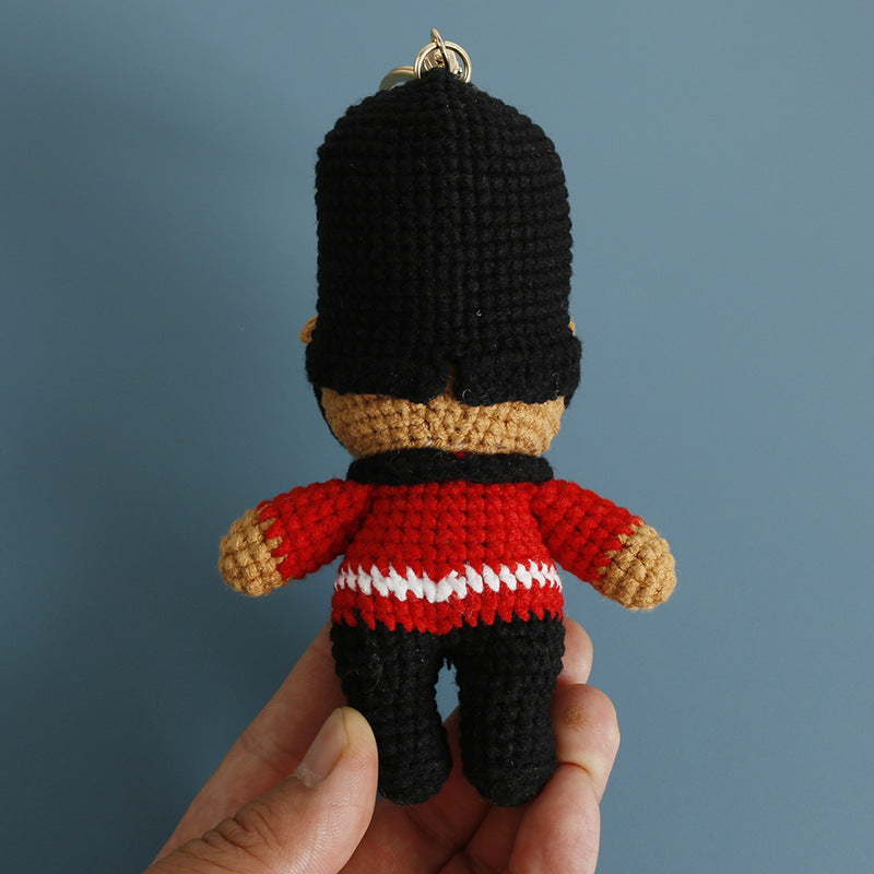 Crochet bear guard keyring on plain background