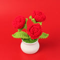 Handmade crochet rose plant in a small decorative pot