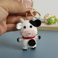 Handmade crochet cow keyring in black and white yarn