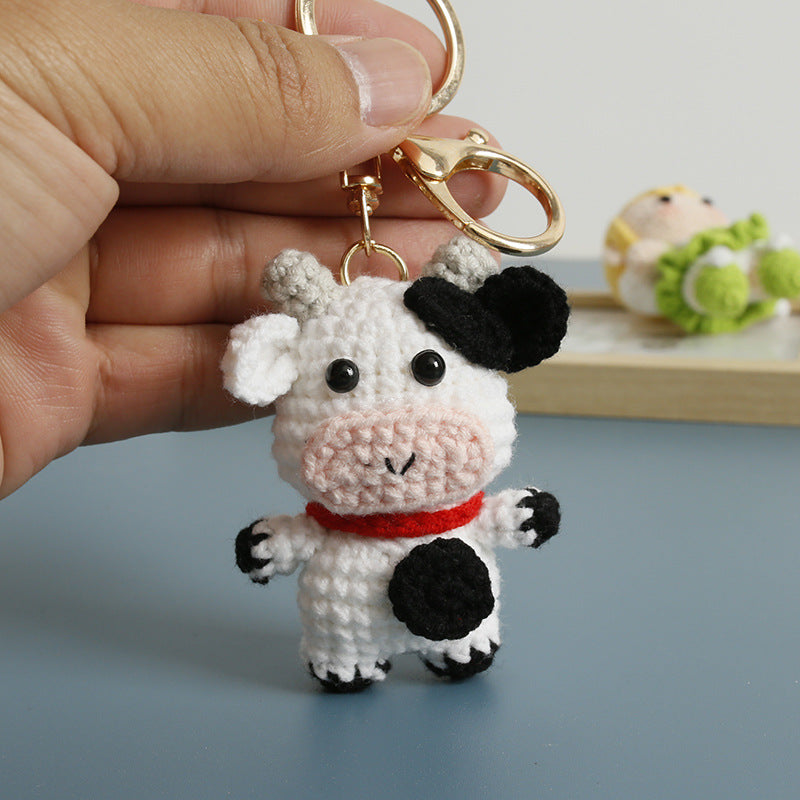 Handmade crochet cow keyring in black and white yarn