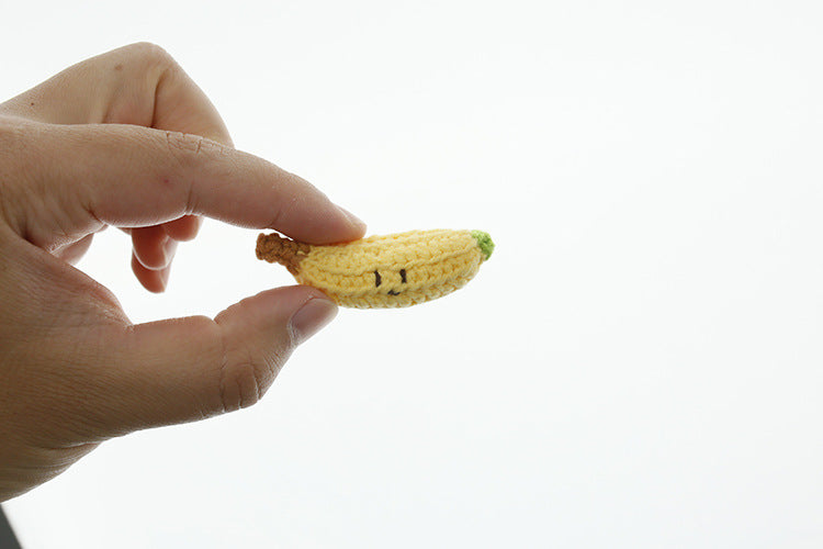 Handmade crochet banana keyring on plain background