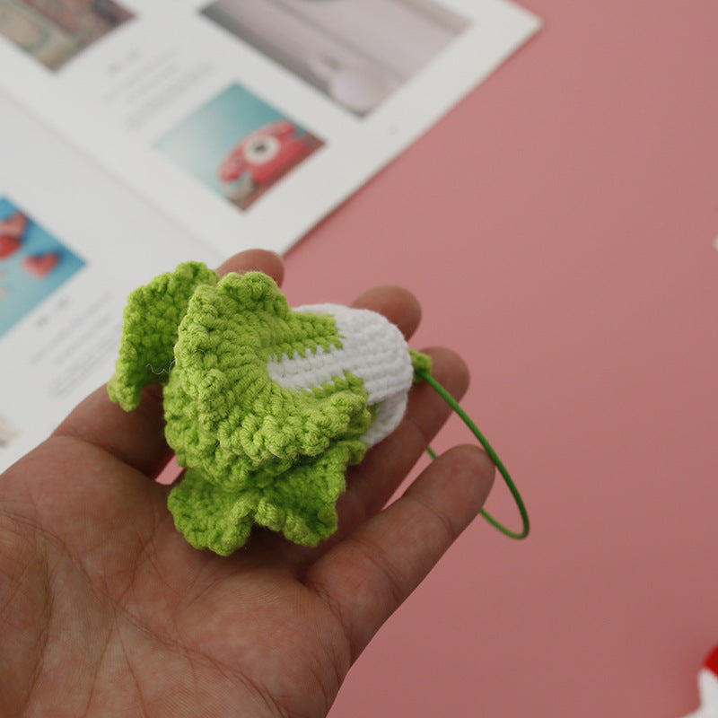 Handmade crochet veggie keyring on plain background
