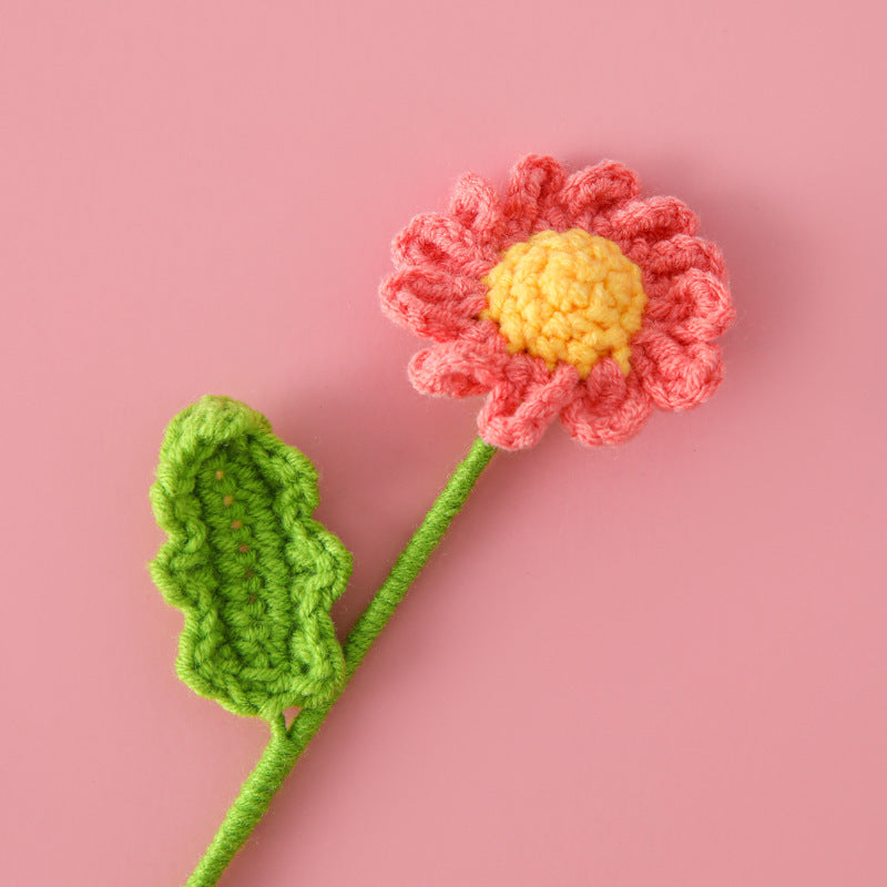Handmade crochet daisy flower stem on plain background