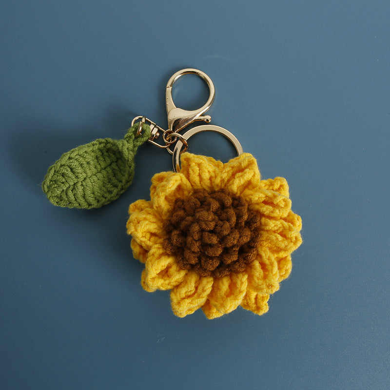 Handmade sunflower crochet keyring on plain background
