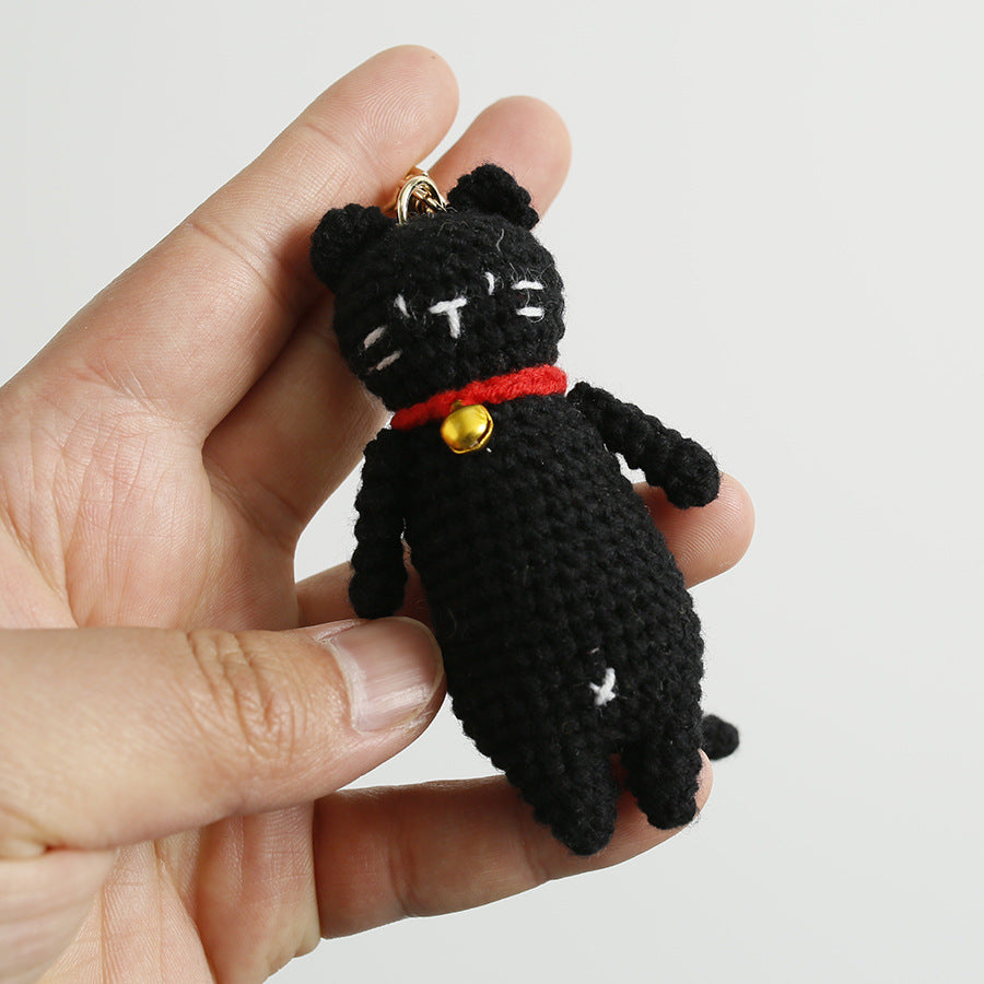 Handmade crochet cat keyring close-up showing embroidered features