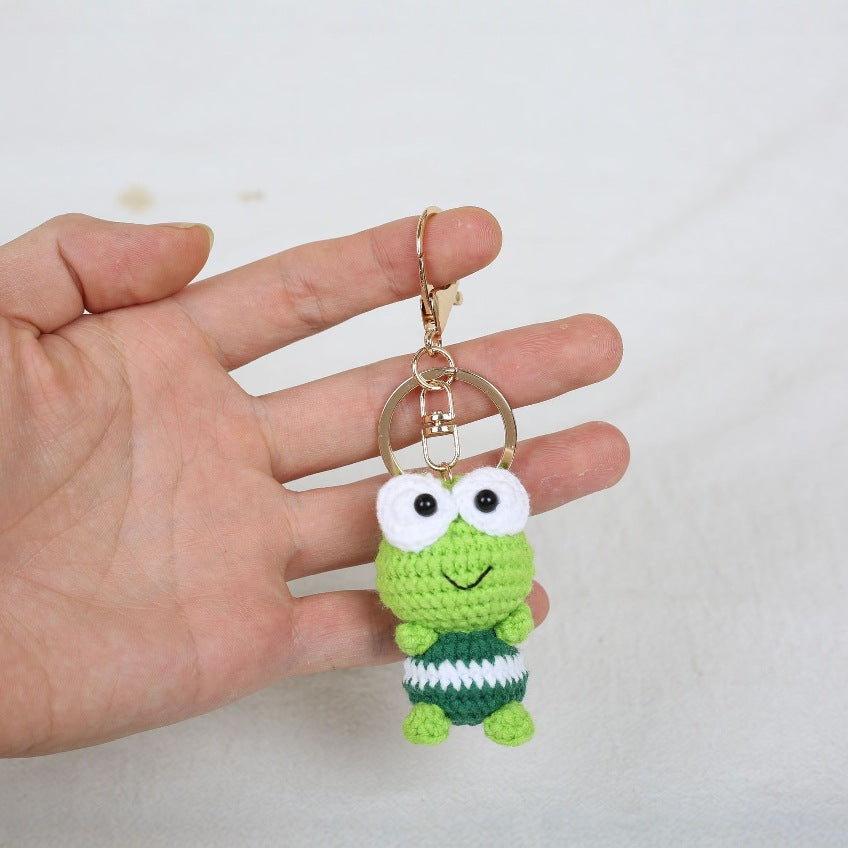Crochet frog keyring close-up showing embroidered eyes