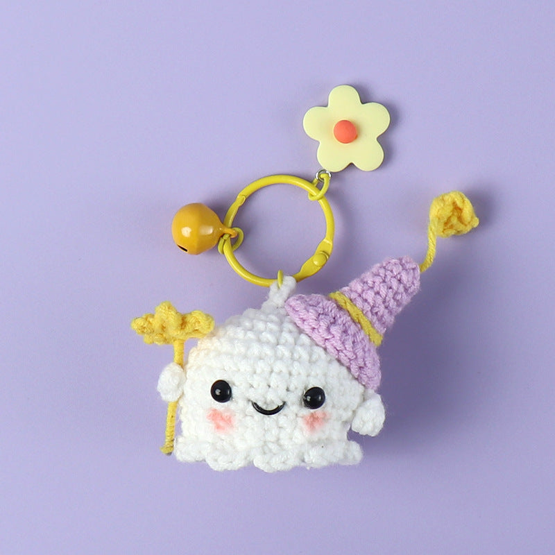 Handmade ghost crochet keyring on plain background