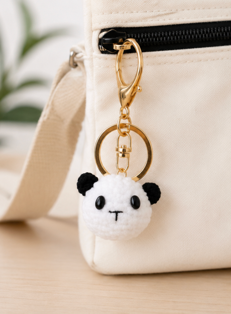 Crochet panda keyring front view showing embroidered face