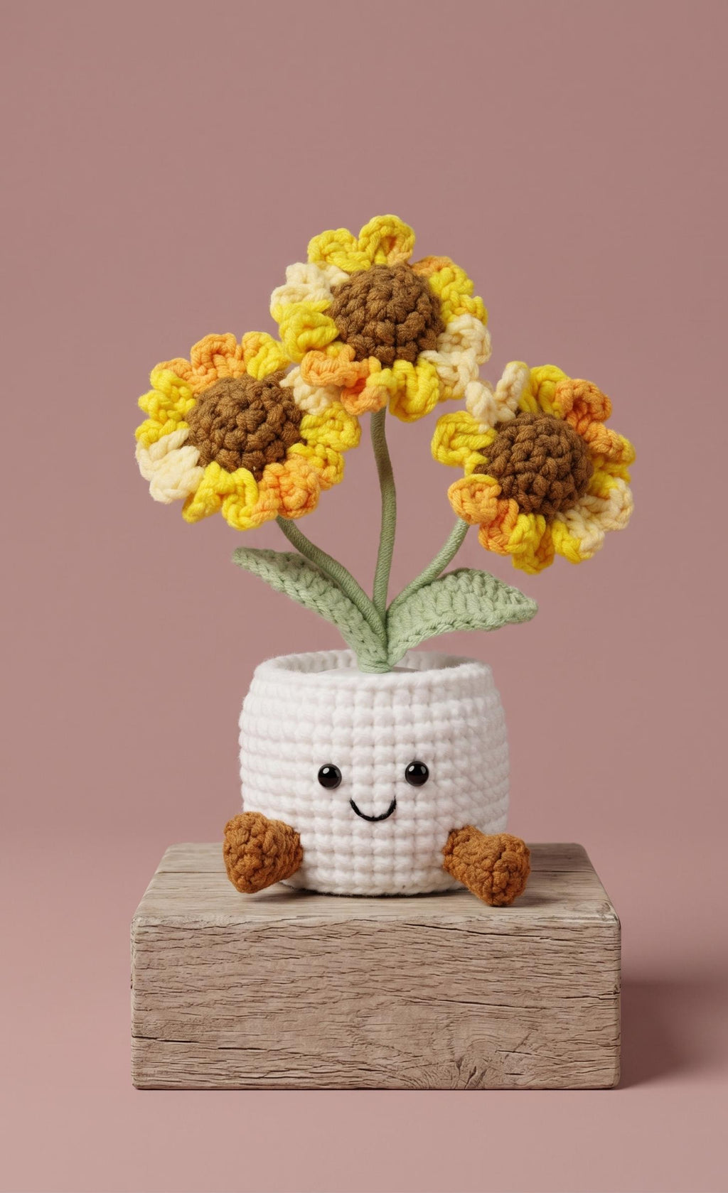 Crochet sunflower plant pot showing three blooms on one stem