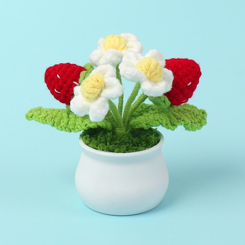 Handmade crochet strawberry plant in a small decorative pot